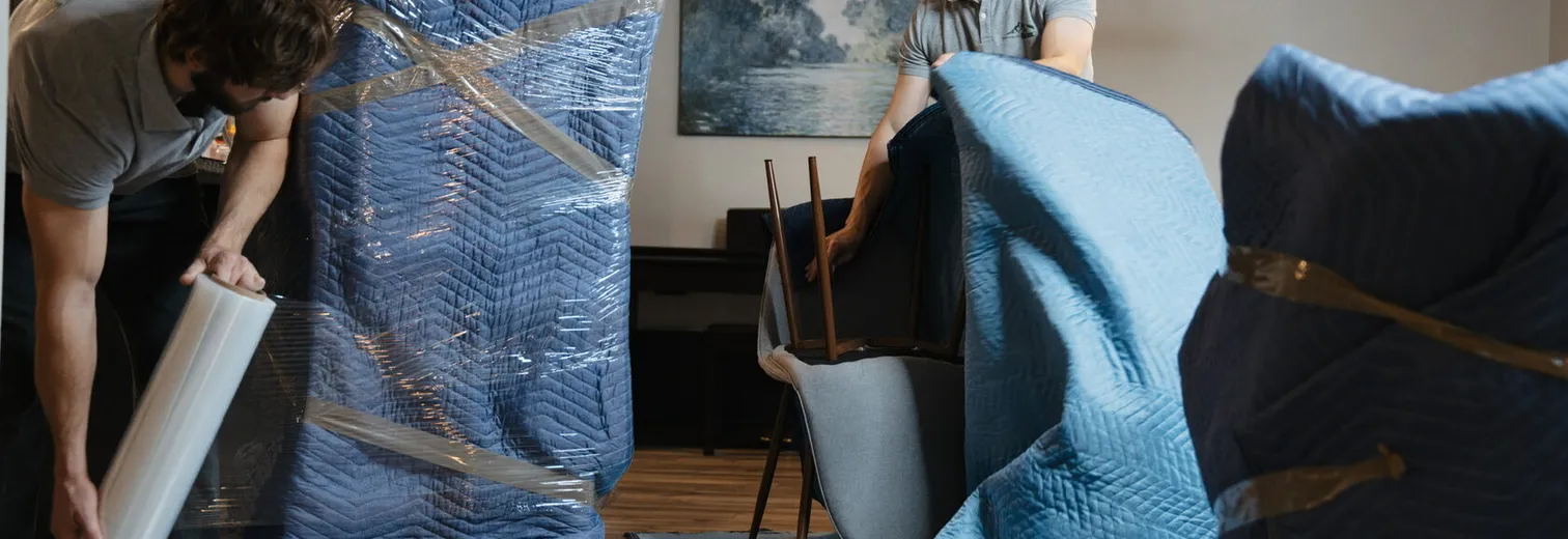 Mount Si Movers crew carefully wrapping furniture in protective plastic film