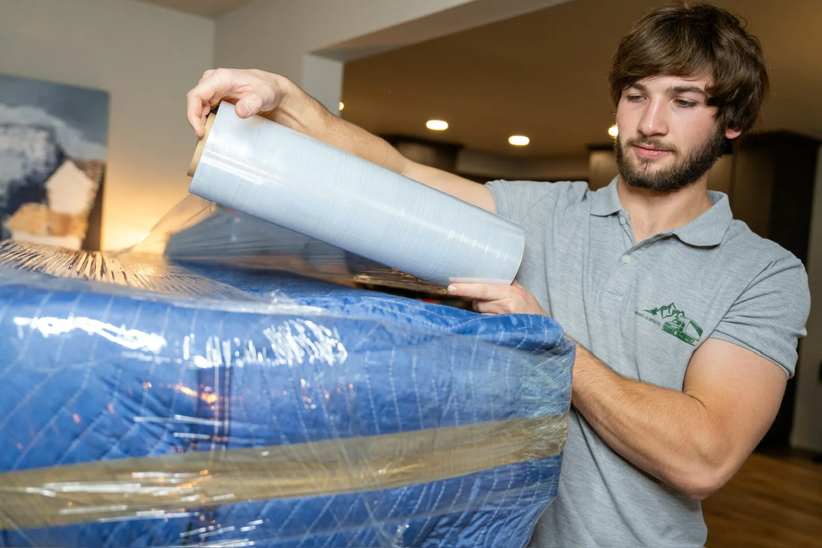 Mount Si Movers crew wrapping furniture in protective plastic film