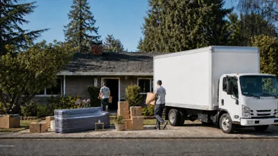 Mount Si Movers truck parked outside a residential home, loaded with boxes and furniture